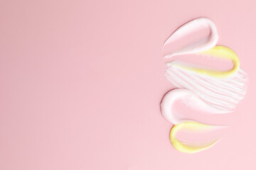 Samples of different cosmetic products on pink background, flat lay. Space for text