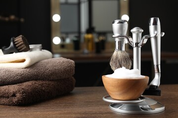 Barber's tools on wooden table in barbershop, closeup