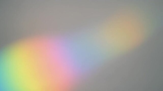 Gentle rainbow light reflection softly moving, dreamy minimal background, smooth motion