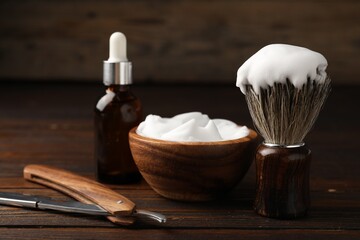 Different barber's tools on wooden table, closeup