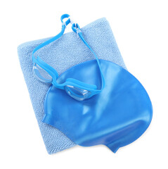 Blue towel, goggles and cap isolated on white, top view. Swimming accessories