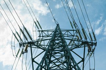 power transmission tower against the blue sky and bright sun