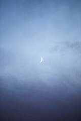Crescent moon in blue twilight sky