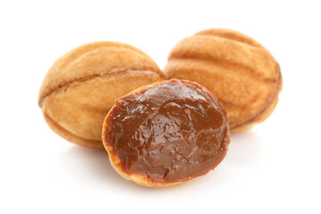 Delicious nut shaped cookies with boiled condensed milk isolated on white