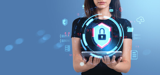 Woman holding digital tablet with glowing padlock hologram showi