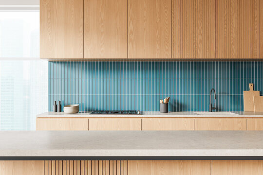 Modern kitchen interior design with light wood cabinets and blue vertical tile backsplash on bright background. 3D Rendering. 3D Rendering