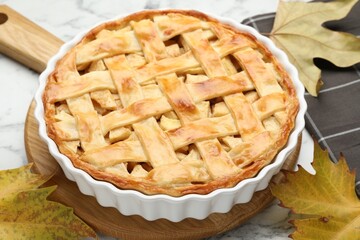 Tasty homemade apple pie on white marble table, closeup
