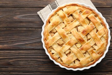 Tasty homemade apple pie on wooden table, top view. Space for text