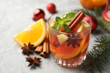Tasty punch drink and spices on light table, closeup. Christmas season