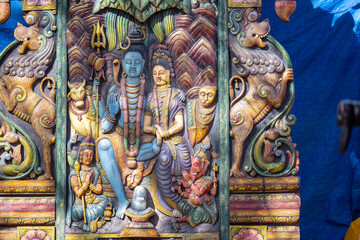 Colorful handmade idol of hindu god shiv in decorated pandal for worship.
