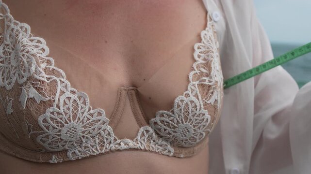 Bra Measuring Woman measuring her chest with a tape measure for size