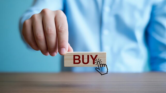 Hand holding wooden block with 'buy' text and cursor icon