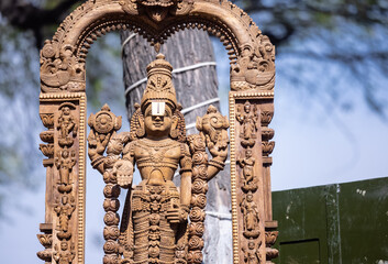 Wooden art, Handmade wooden idol on lord tirupati at surajkund craft fair. Selective focus.