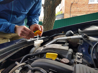 Learning to check car fluids in the driveway