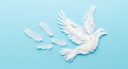 Fototapeta premium A white dove, constructed from feathers, takes flight, leaving a trail of feathers behind on a light blue background.