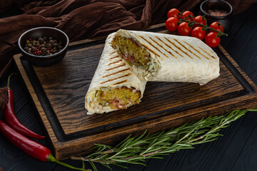 Vegetarian doner with falafel on a wooden tray