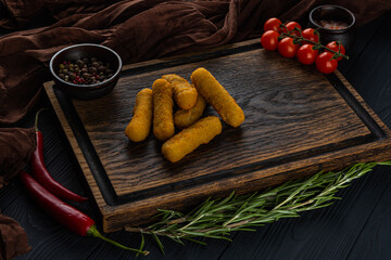 Cheese sticks on a wooden tray