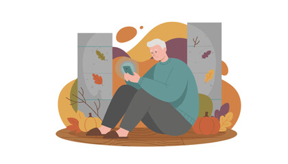 Elderly man sits sadly fixated on his smartphone screen in an isolated autumnal setting