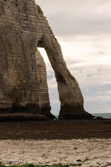 White chalk cliffs and natural arch at Étretat, Normandy, France, overlooking the turquoise sea. Scenic coastal landscape famous for its dramatic beauty and ocean views.