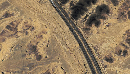 Lonely Highway: Aerial View of a Desert Road Cutting Through Saudi Arabia's Sands