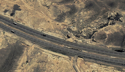 Lonely Highway: Aerial View of a Desert Road Cutting Through Saudi Arabia's Sands