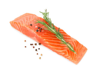 Piece of salmon fillet with spices isolated on white