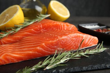 Pieces of salmon fillet and spices on table, closeup