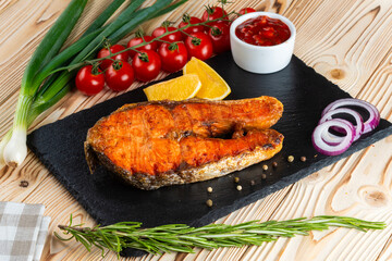 Grilled salmon, shashlik on a wooden table