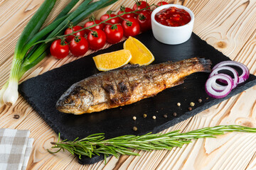 Grilled trout shashlik on a wooden table