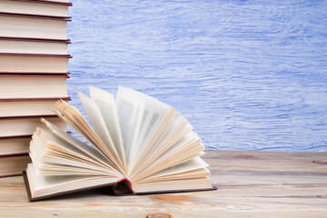 open book, books on the blue background. Back to school. Education. Copy space for text.