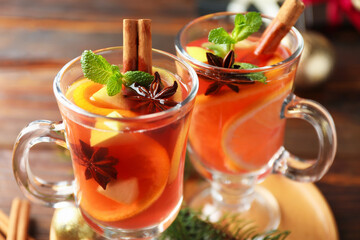 Tasty punch drink on wooden table, closeup. Christmas season