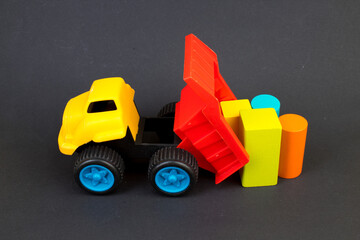 Children's toy, a multi-colored steam locomotive on a black background.