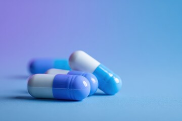 Blue and White Capsule Pills on Blue Background Pharmaceutical Medication Healthcare and Medical Treatment Concept Dosage Tablet Drugs Medicine Antibiotics Painkillers Vitamins