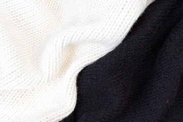 Knitted woolen sweaters. A bunch of knitted winter, autumn clothes, sweaters, knitwear, space for the text.