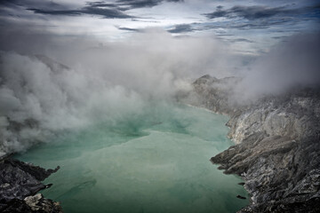 The acidic lake of Kawah Ijen in its fog