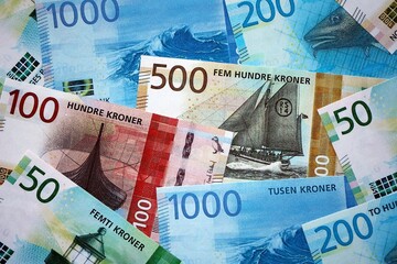 Norwegian Krone currency money bills. NOK currency banknotes in pile with different denomination close up