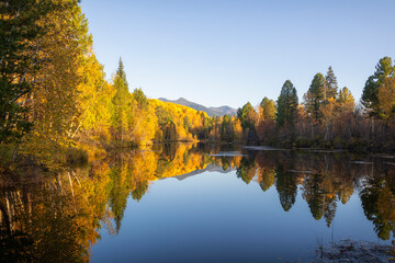 Autumn landscape with mountains and a lake. Russia. Siberia.