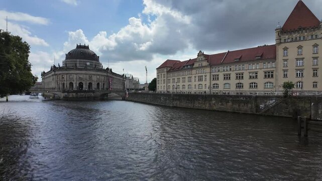 historical downtown district of berlin, germany, with view to famous museum island, boat traffic on spree river, summer day ouside in 2024, time lapse totale with motion blur