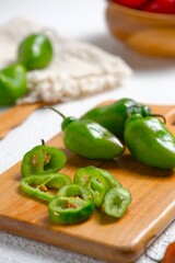 Uncooked fresh Habanero chili (Capsicum chinense) or cabe gendot or cabe bendot on board. These...