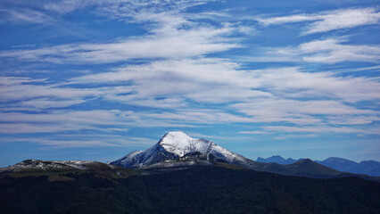 Mount Hilarrieta (1387 m) surrounded by forests and clouds