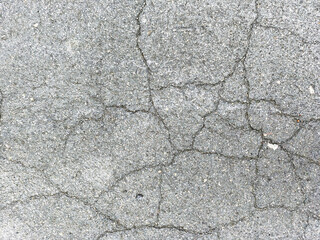 Cracked asphalt texture background with visible damage and imperfections