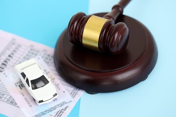 Generic driving license and judgement mallet on blue background close up