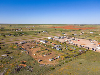 Obraz premium Aerial landscape of desert car graveyard in rural historic US route 66 Tucumcari New Mexico NM
