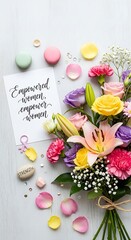 Colorful floral arrangement with inspirational card on white surface