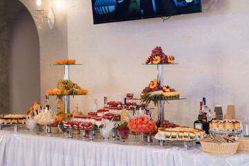 Elegant Buffet Table Display with Fresh Fruits, Desserts, and Beverages at a Formal Event or Wedding Reception