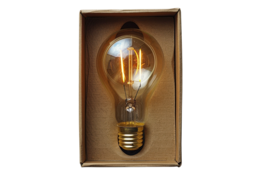 Vintage style edison light bulb glows warmly inside a cardboard box ready for shipping or display on transparent background