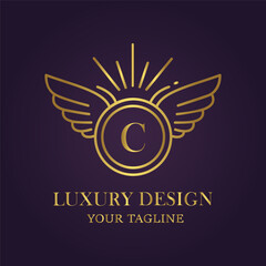 Elegant golden winged emblem with letter c, luxury design and tagline on dark purple background