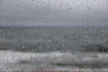 Rain droplets are seen on the window glass