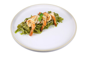 A culinary masterpiece, green pasta topped with succulent shrimps on a plate. The pasta and shrimps are arranged artfully, inviting the viewer to savor the visual feast.