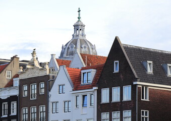 Damrak House Facades Close Up with Sint Nicolaaskerk Church Dome in Amsterdam, Netherlands © Monica
